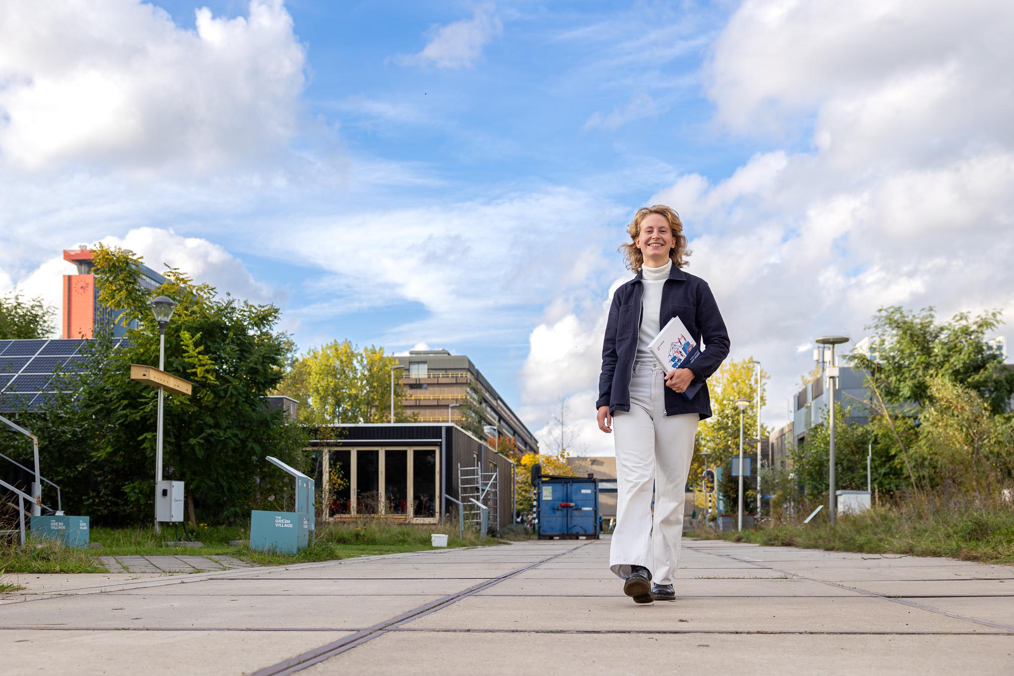 Odile Niers walking with a book 